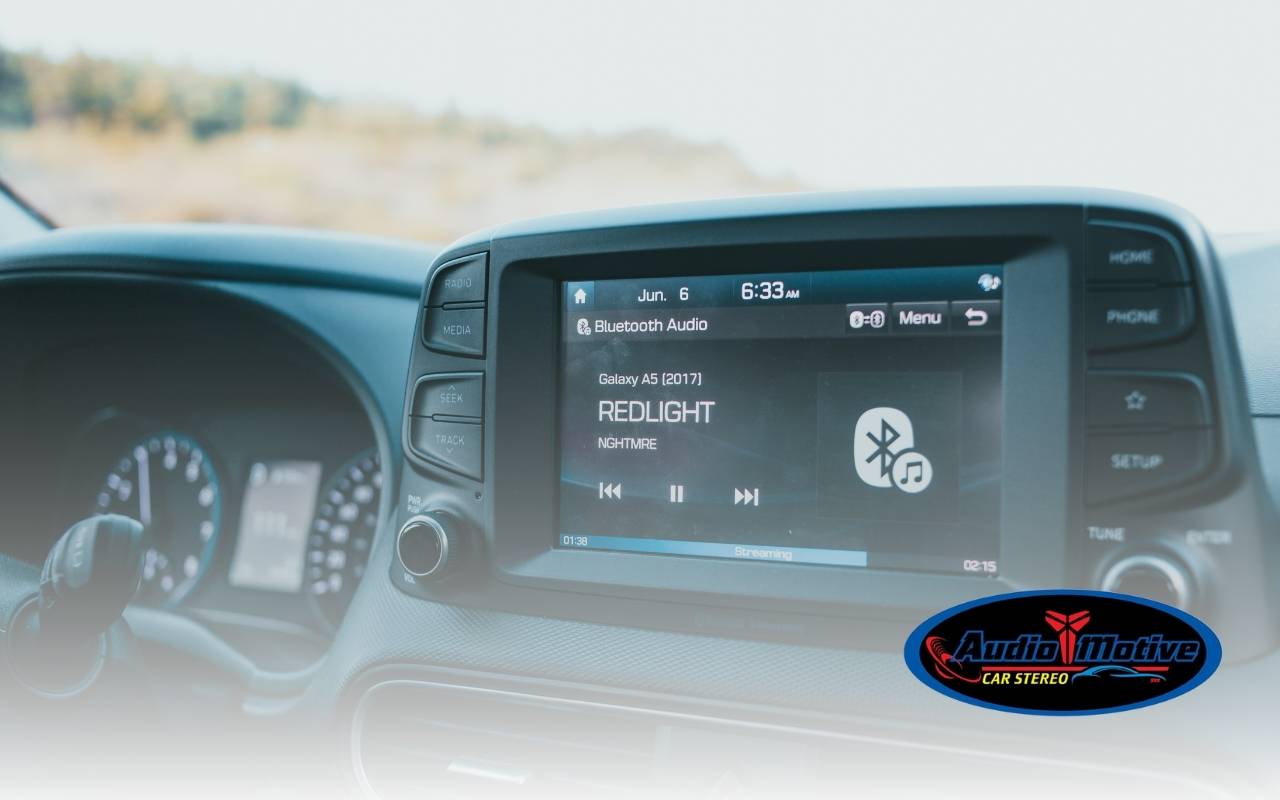 Installer working on car audio wiring to highlight typical labor cost car audio in a San Leandro shop.