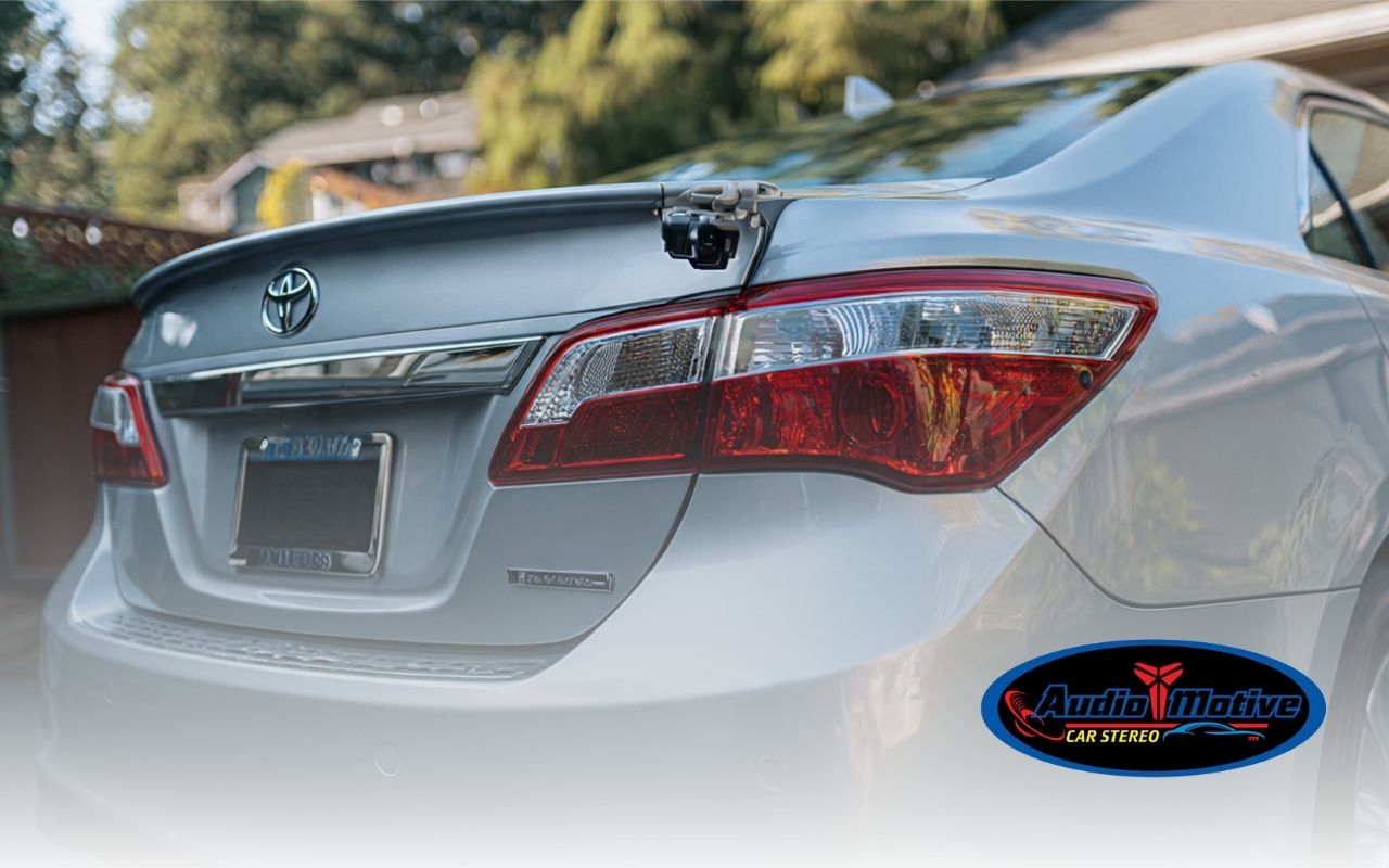 Backup camera installation in Fremont with a license plate mount on a sedan