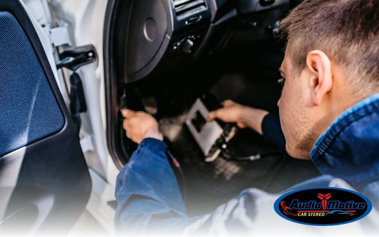 Technician installing a car alarm system in San Leandro.