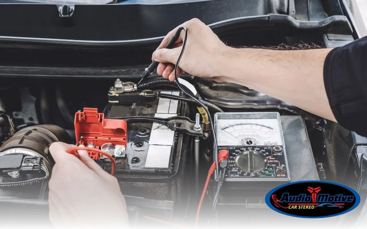 Person checking amplifier ground with a multimeter