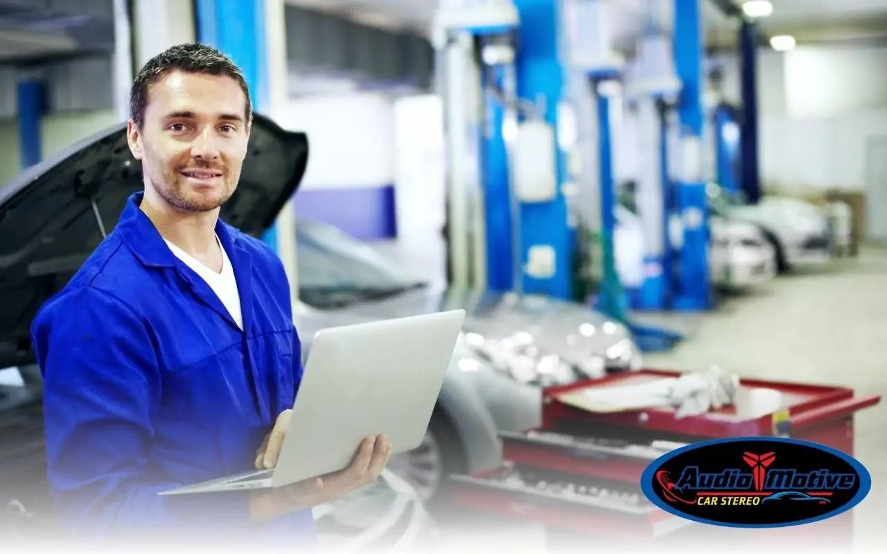 Audiomotive technician tuning DSP in a customer vehicle