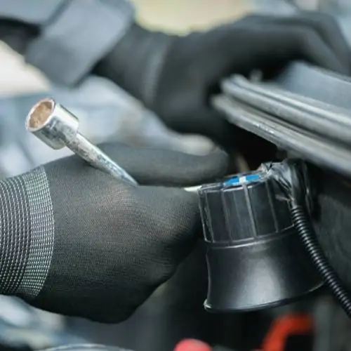 Car alarm installation technician working on vehicle in Fremont, CA