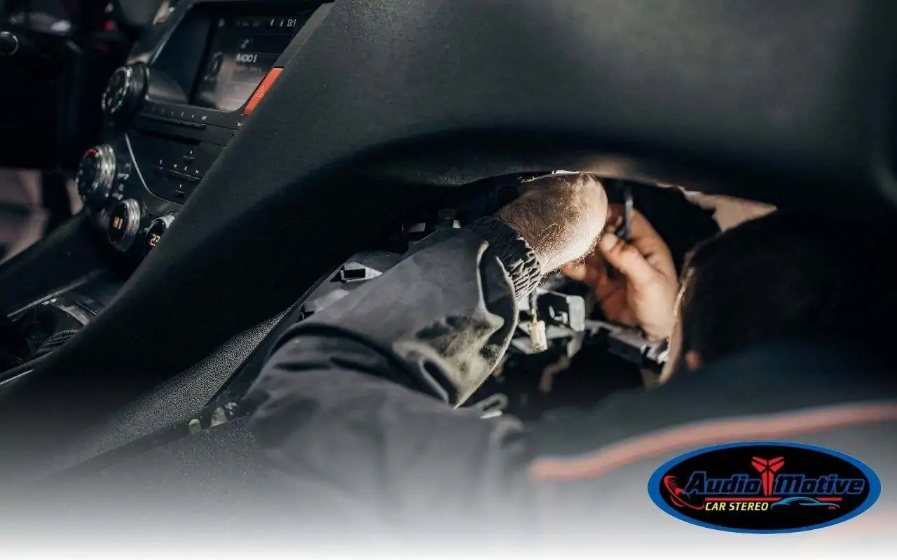 Technician installing a hidden ghost immobilizer in a car